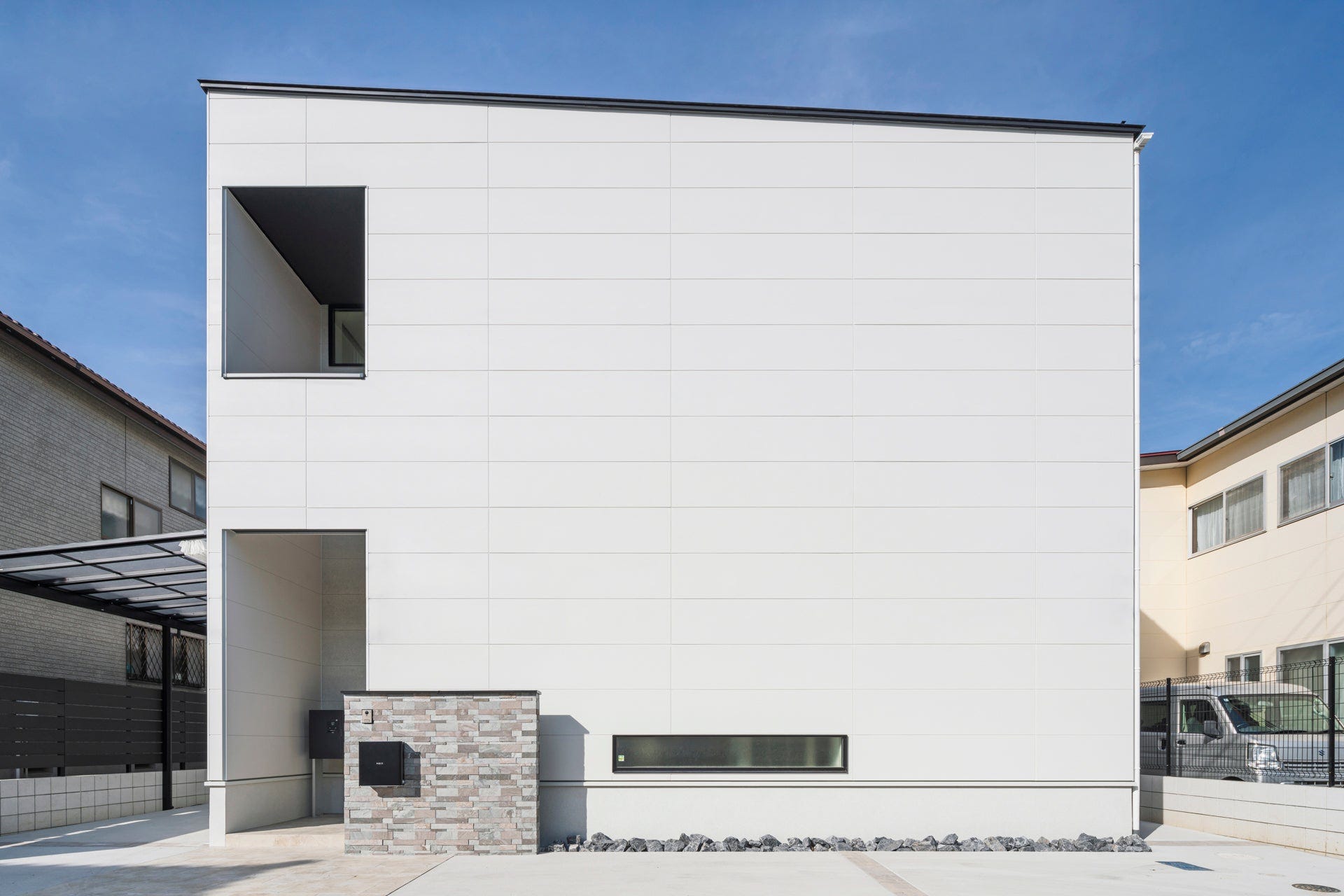 建築工房 櫓　光のふる家 (東南側の道路付となる敷地環境で、あえて道路側からの外観では大きな開口部を作らず、シンプルなファサードとしています。
建物内部に足を踏み入れると、吹抜けのポーチ、塗り壁の玄関ホール、吹抜けと鉄骨階段の階段ホール、2階ホールと連続するアイランドキッチン、大開口を設けた天井高さ３ｍのリビングダイニングと、シーンごとに見せ場が続く空間構成となっています。
また地窓・天窓・室内窓・リビングダイニングの大開口などにより、各所で光のあふれる豊かな空間が実現しました。
ーーーーーーーーーーーーーーーーーーーーーーーー
敷地面積：198.96㎡　延床面積：171.55㎡　間取り：6LDK)